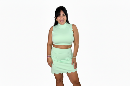 Woman wearing a bright green outfit on a white background